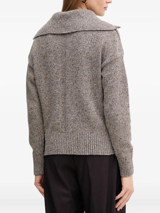 Grey knitwear worn by a person, showing the knitwear's fit