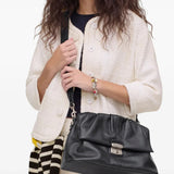 Black bag worn by a person, showing the bag's fit