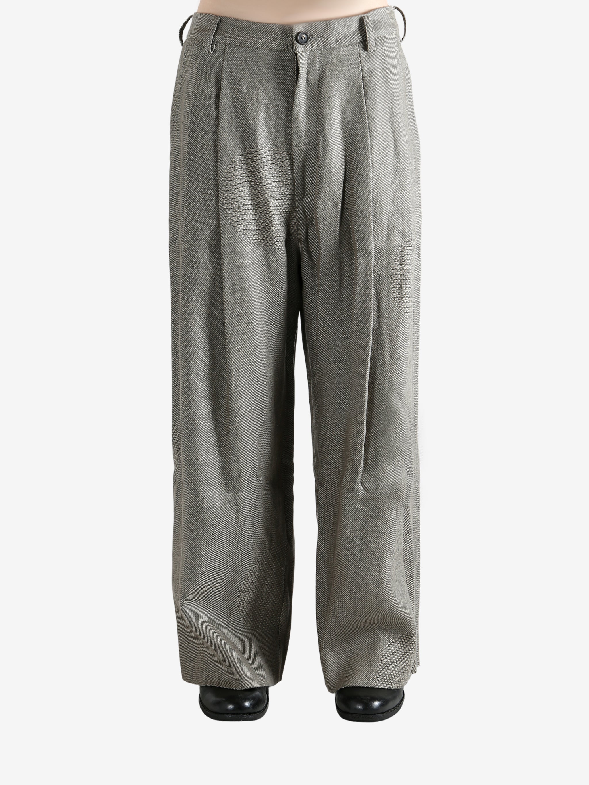 Grey pants worn by a person, showing the pants' fit