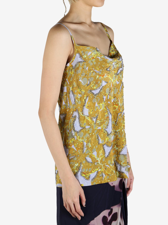 Yellow top worn by a person, showing the top's fit