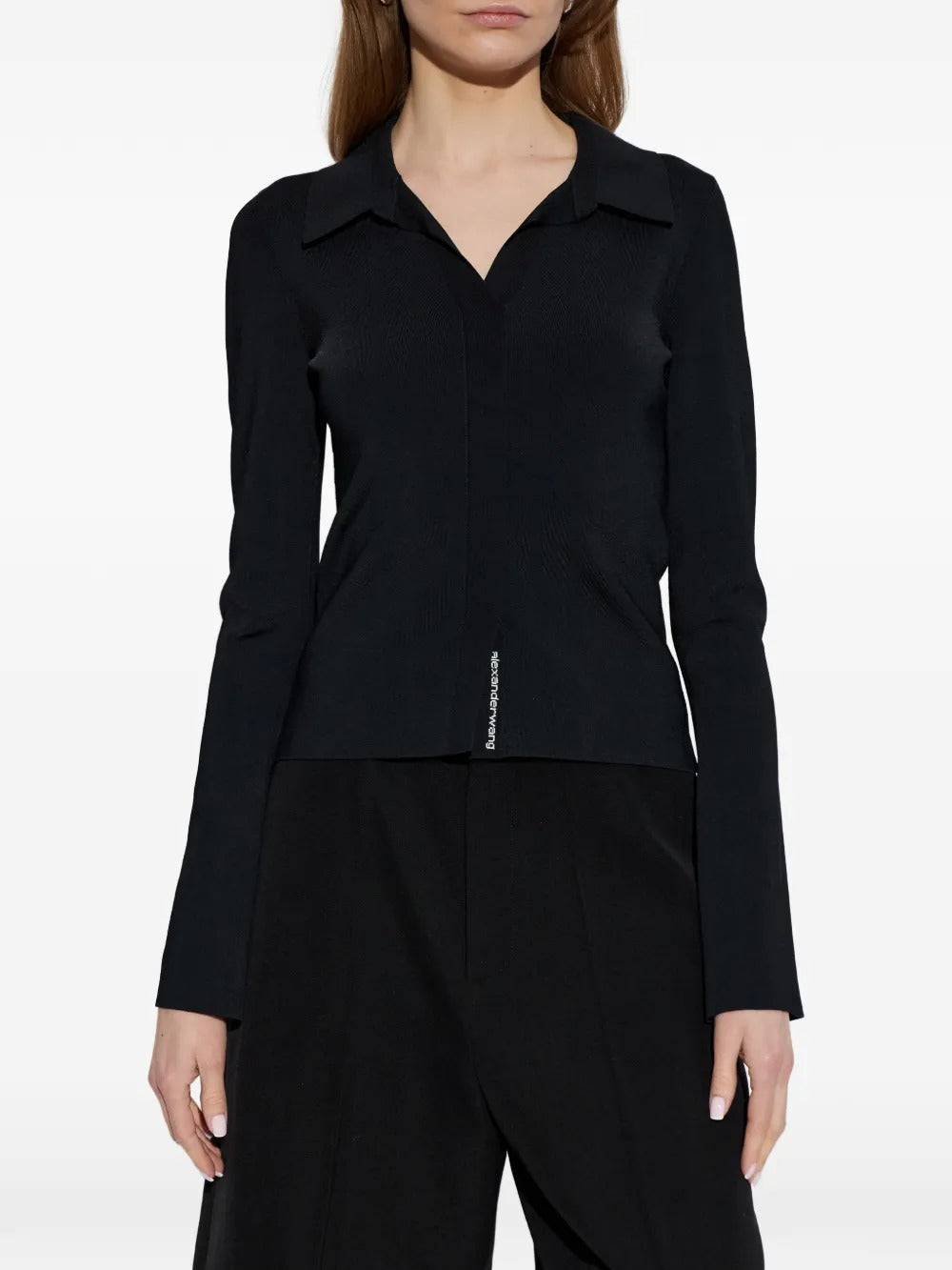 Black top worn by a person, showing the top's fit