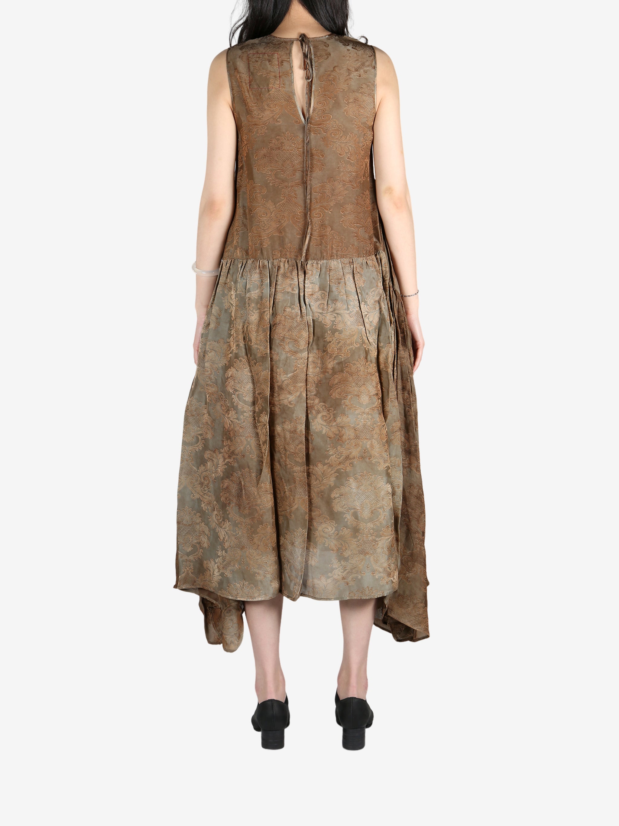 Brown dress worn by a person, showing the dress's fit