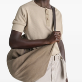 Brown bag carried by a person, showing the bag's fit