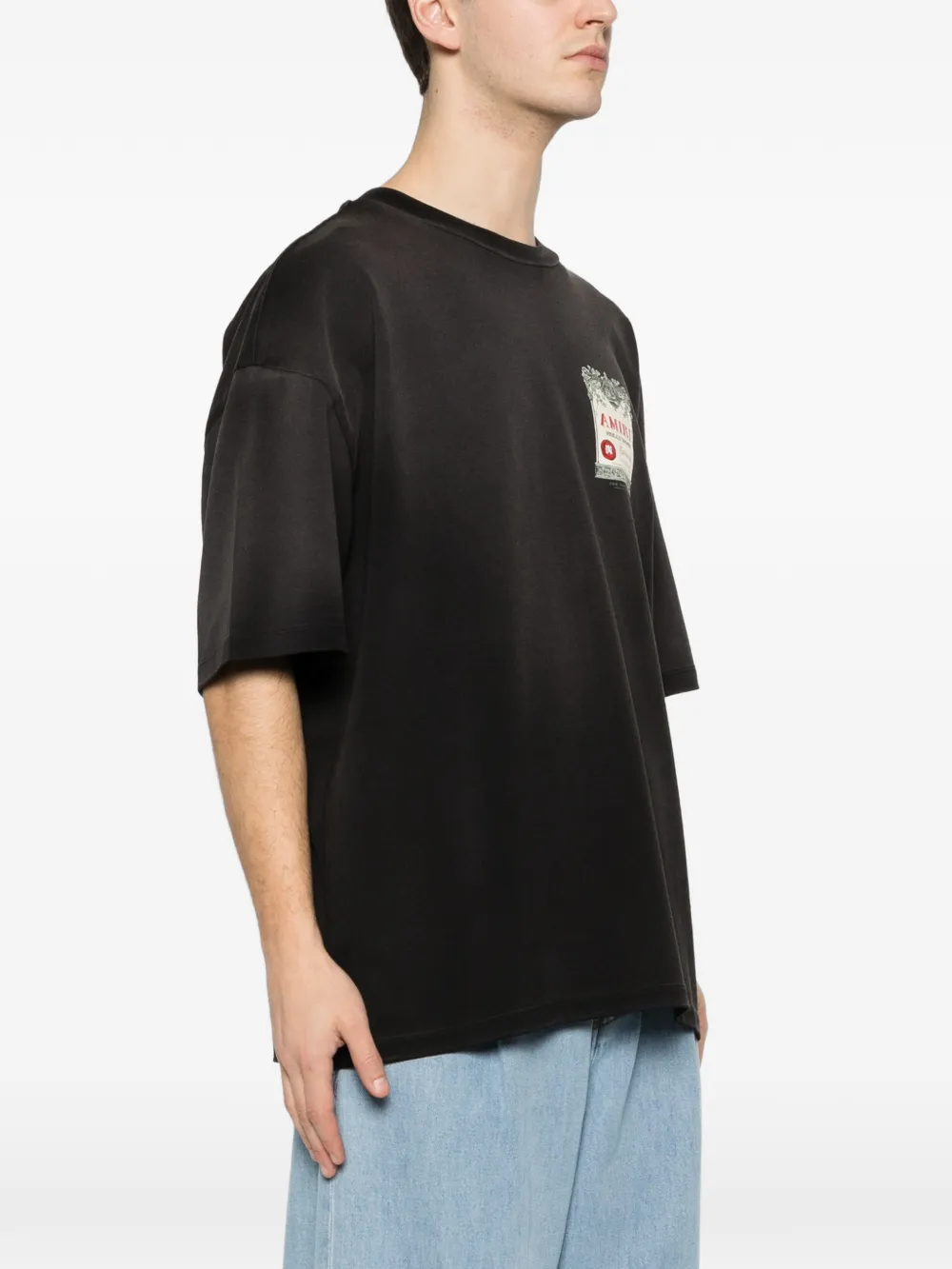 Black t-shirt worn by a person, showing the t-shirt's fit
