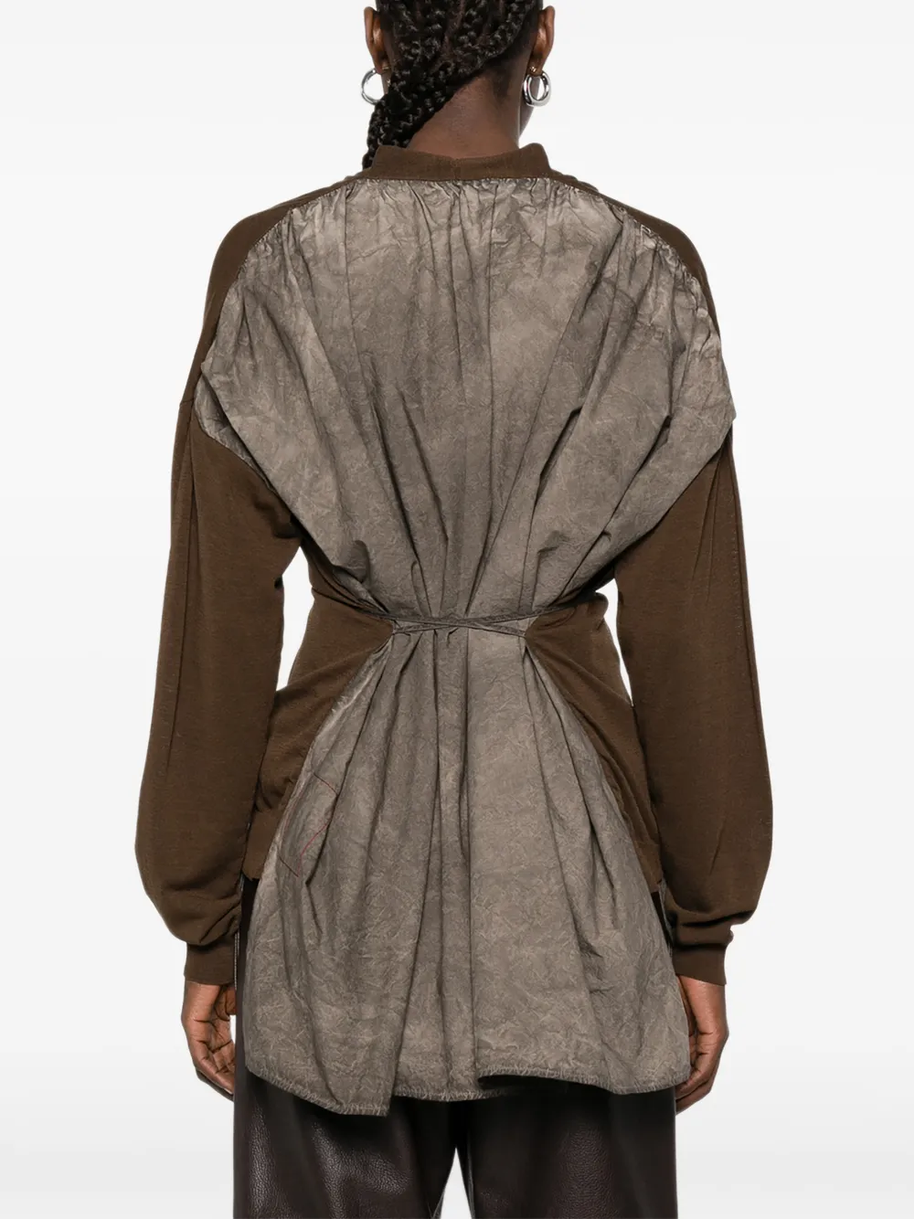 Brown knitwear worn by a person, showing the knitwear fit