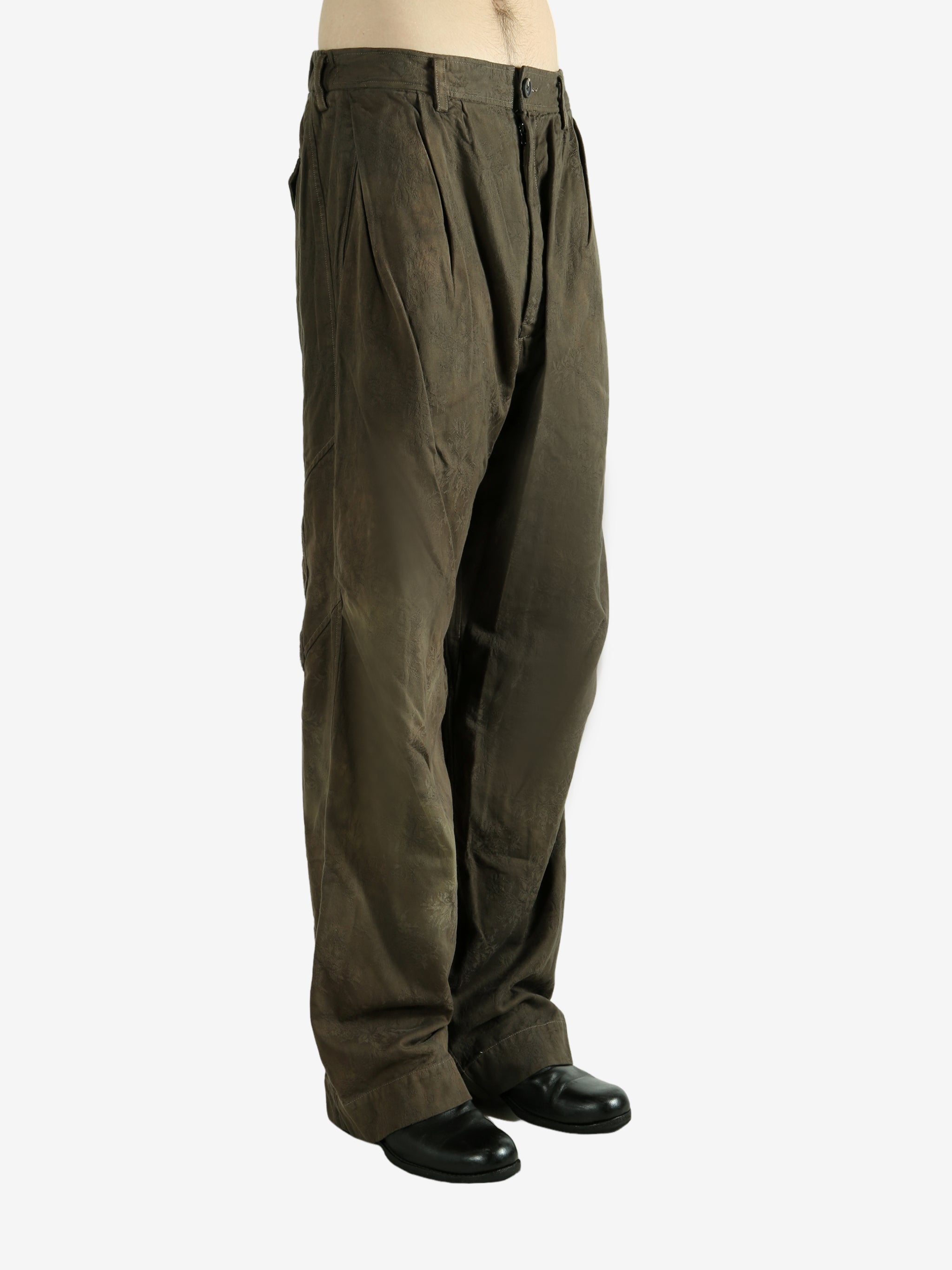 Green pants worn by a person, showing the pants fit