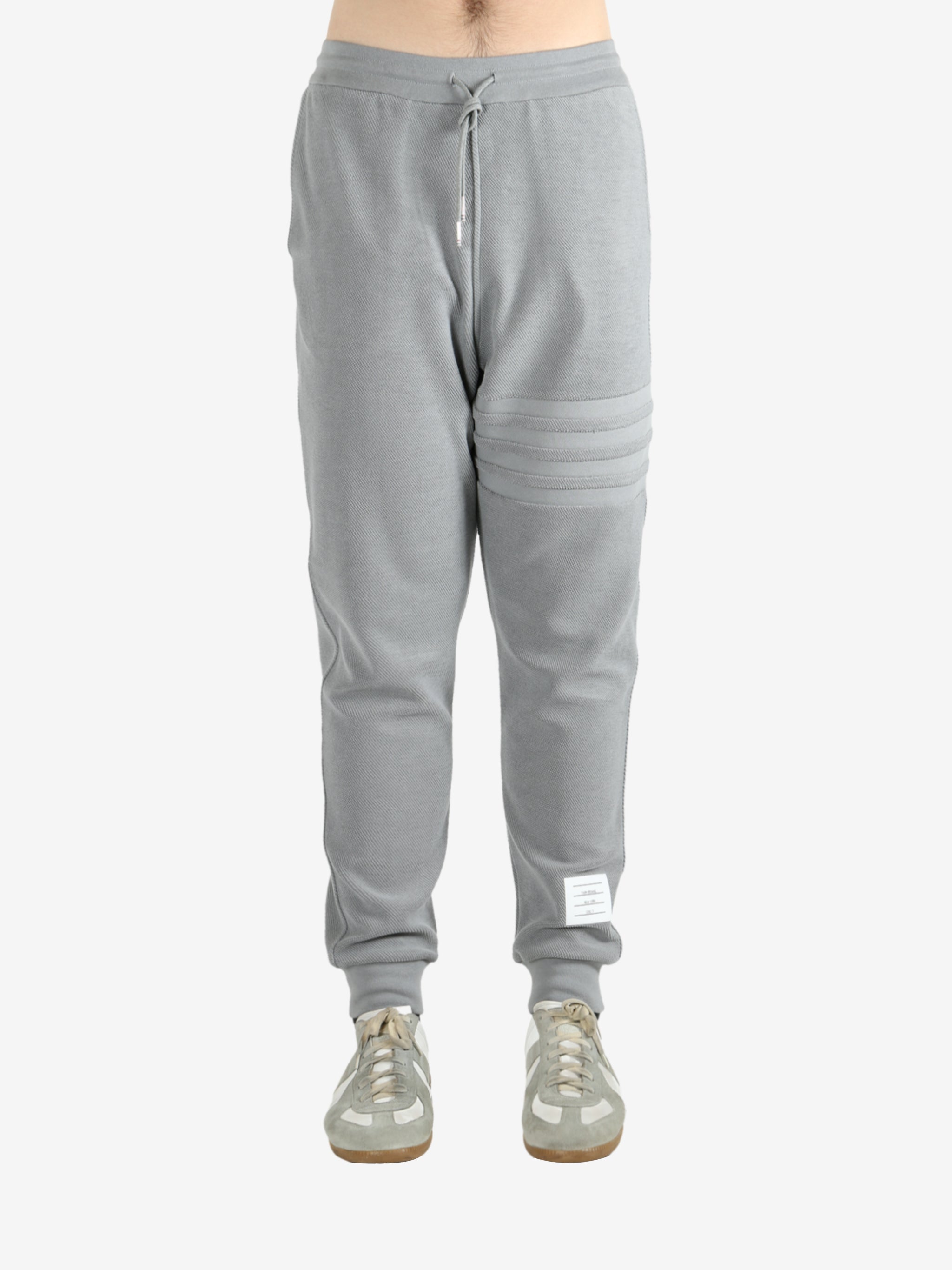 Grey pants worn by a person, showing the pants fit