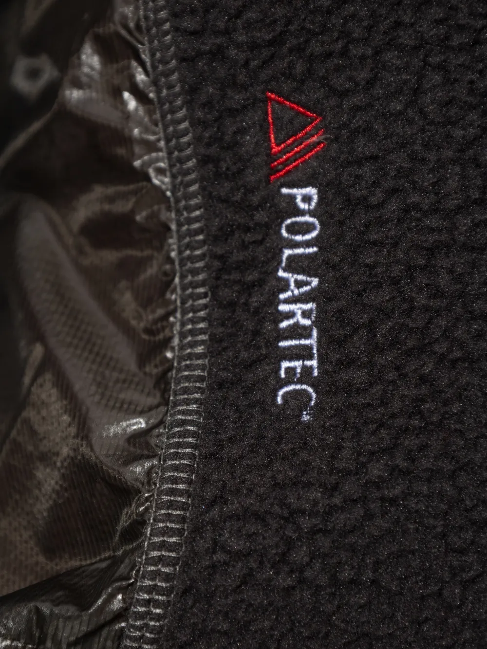 Close up of black hoodie, showing texture of the Polyester and  Polyamide fabric