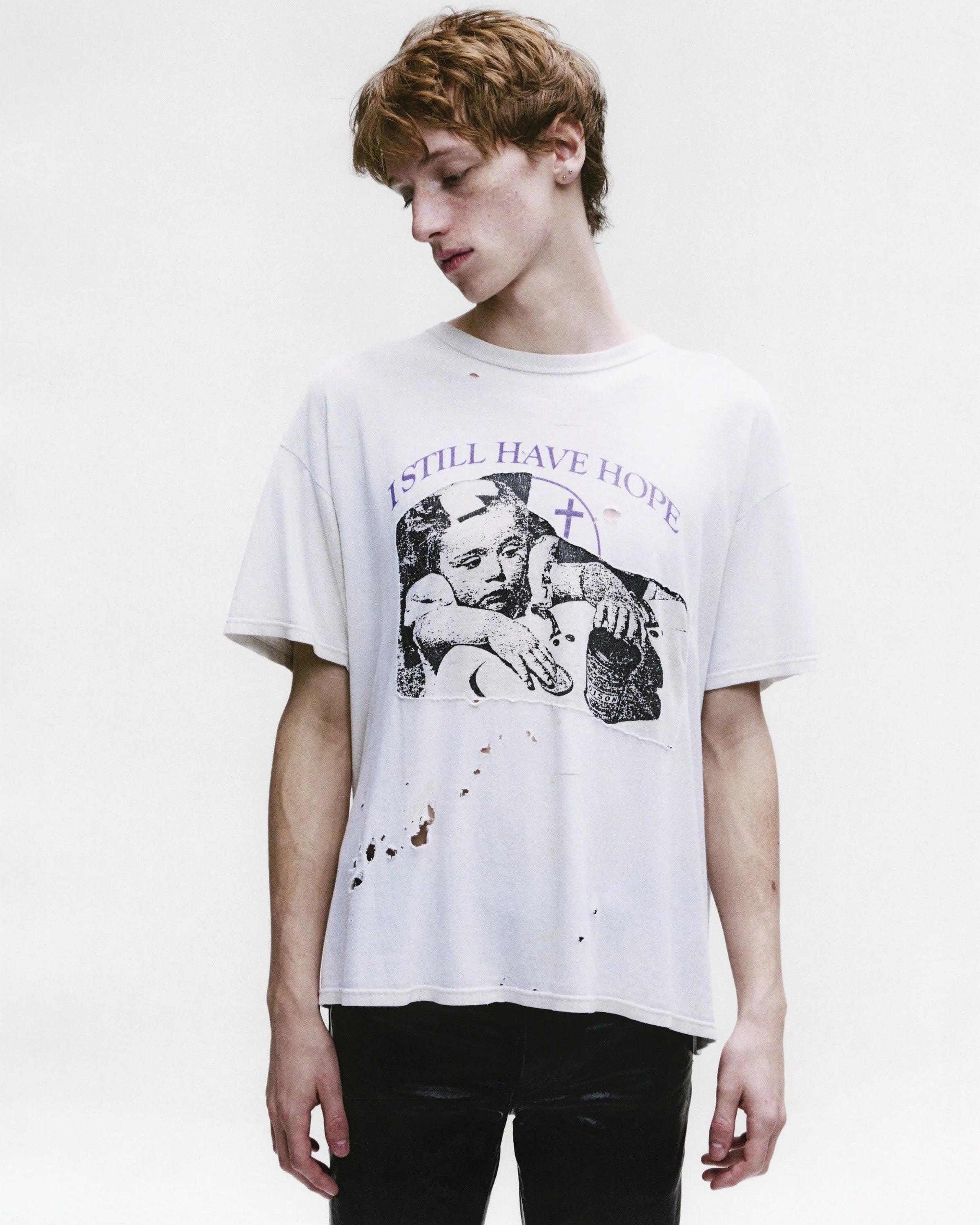 White t-shirt worn by a person, showing the shirt's fit