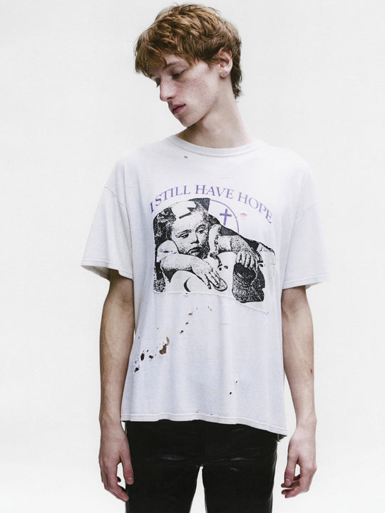 White t-shirt worn by a person, showing the shirt's fit