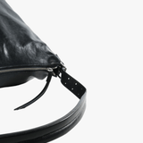 Close up of black bag, showing texture of the leather fabric