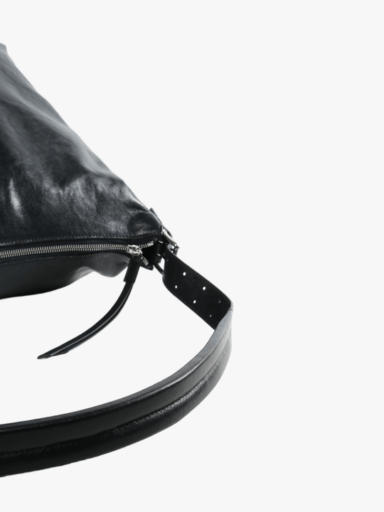 Close up of black bag, showing texture of the leather fabric