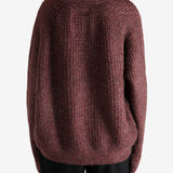 Red cardigan worn by a person, showing the cardigan's fit