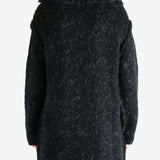 Black coat worn by a person, showing the coat's fit