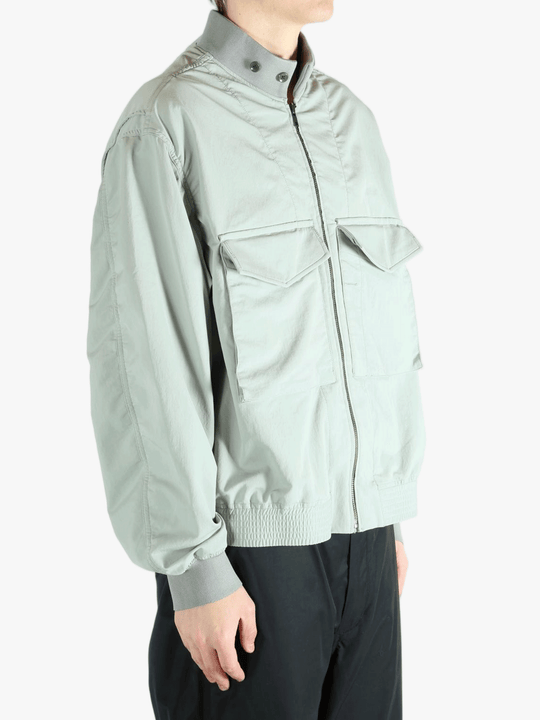 Grey jacket worn by a person, showing the jacket's fit
