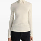 White top worn by a person, showing the top's fit