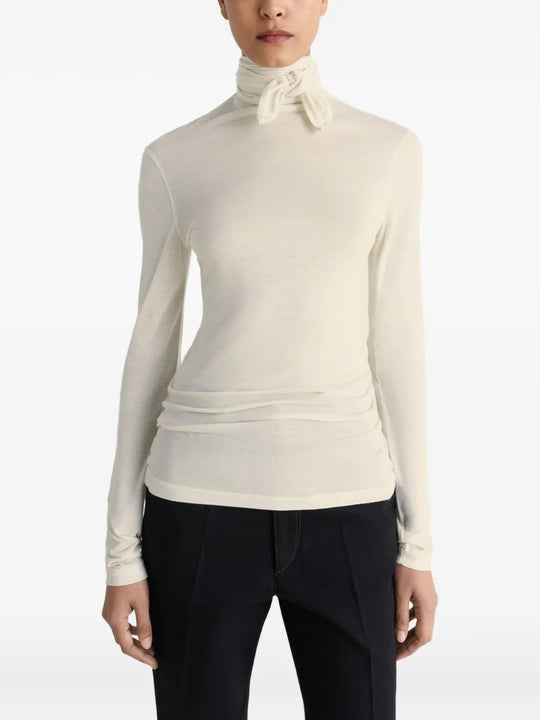 White top worn by a person, showing the top's fit