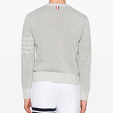 Grey knitwear worn by a person, showing the knitwear’s fit