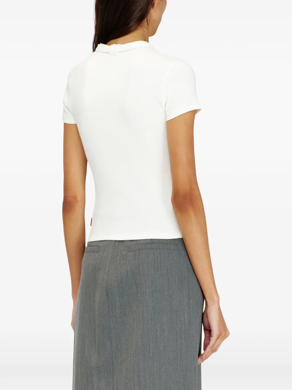White top worn by a person, showing the top's fit