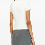 White top worn by a person, showing the top's fit