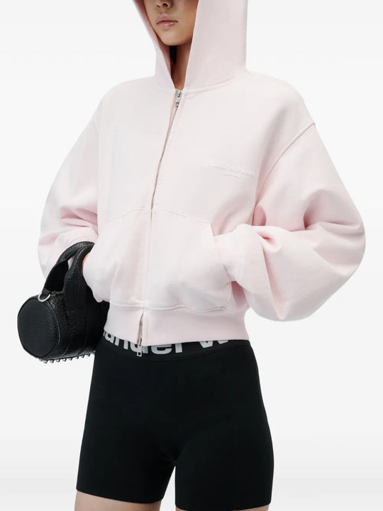 Pink hoodie worn by a person, showing the hoodie fit