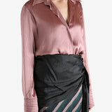 Pink shirt worn by a person, showing the shirt's fit