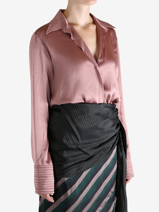 Pink shirt worn by a person, showing the shirt's fit