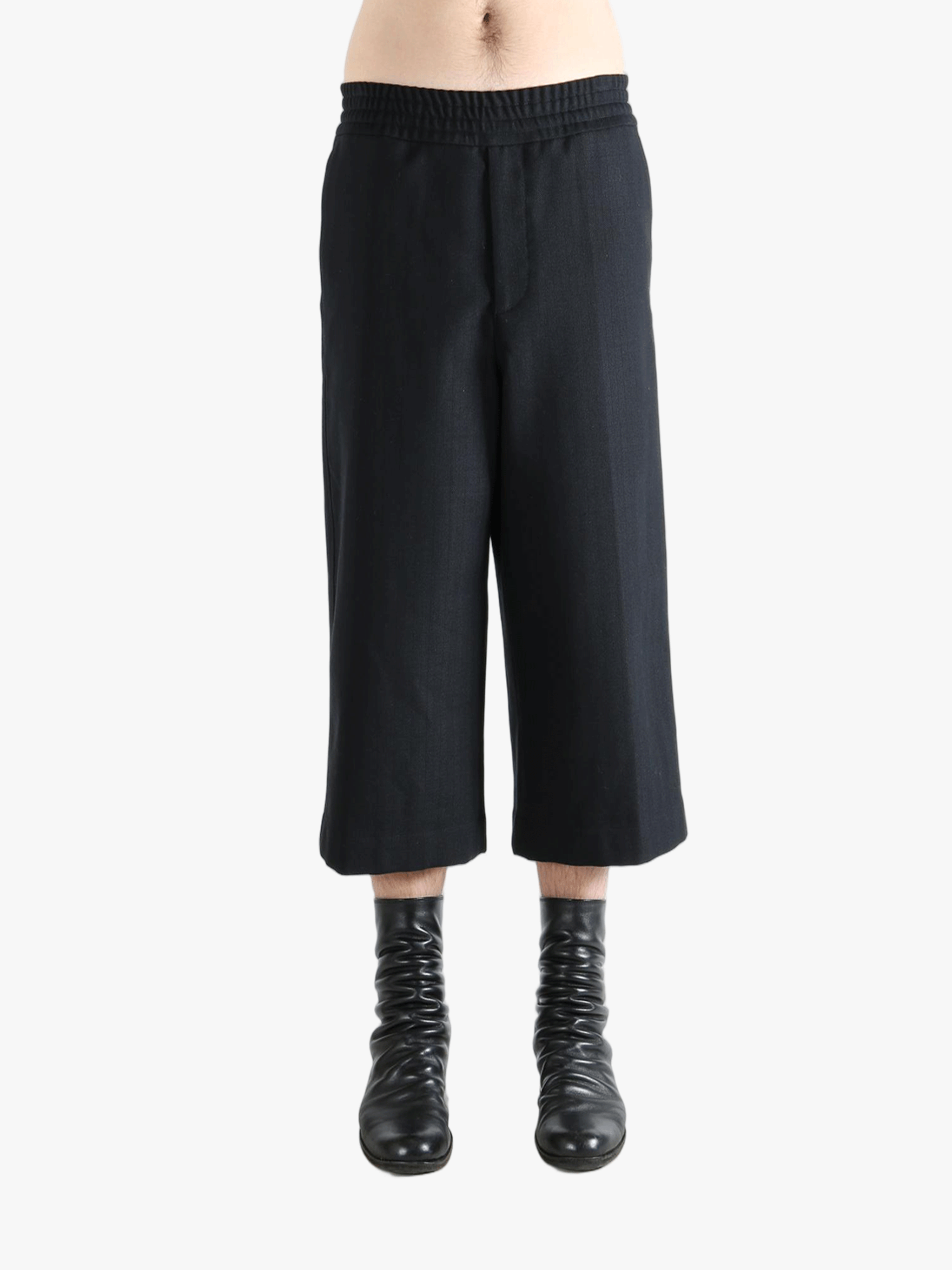 Black pants worn by a person, showing the pants's fit