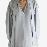 Grey blouse worn by a person, showing the blouse's fit