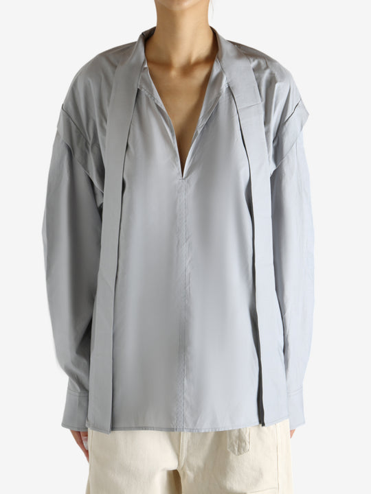 Grey blouse worn by a person, showing the blouse's fit