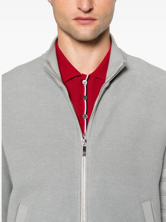 Close up of the grey jacket, showing texture of the cotton fabric