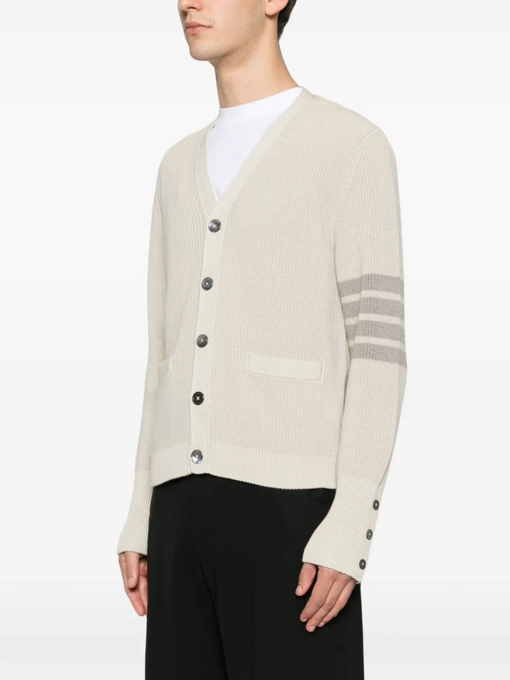 White cardigan worn by a person, showing the cardigan's fit