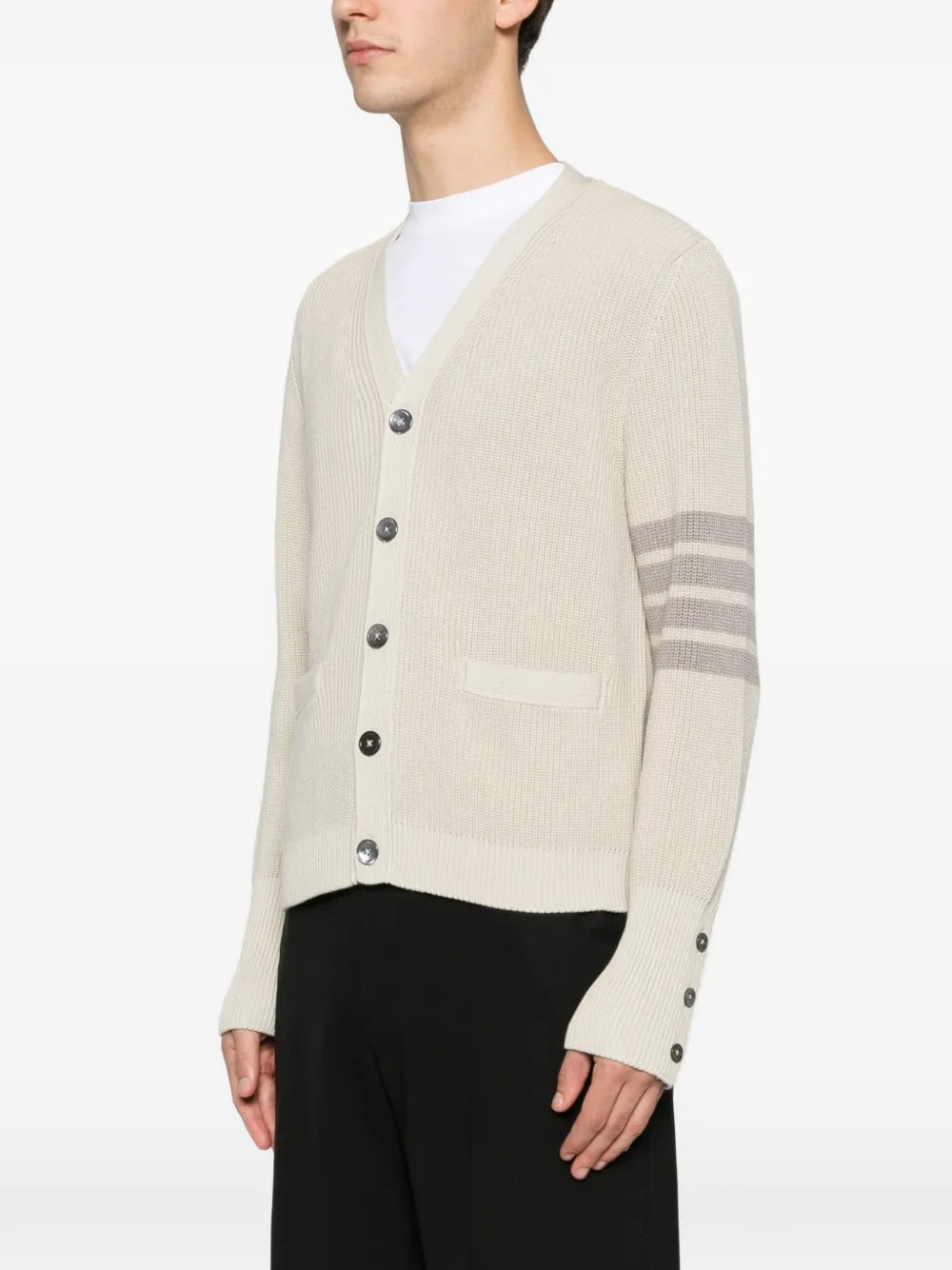 White cardigan worn by a person, showing the cardigan's fit