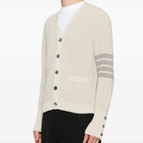 White cardigan worn by a person, showing the cardigan's fit