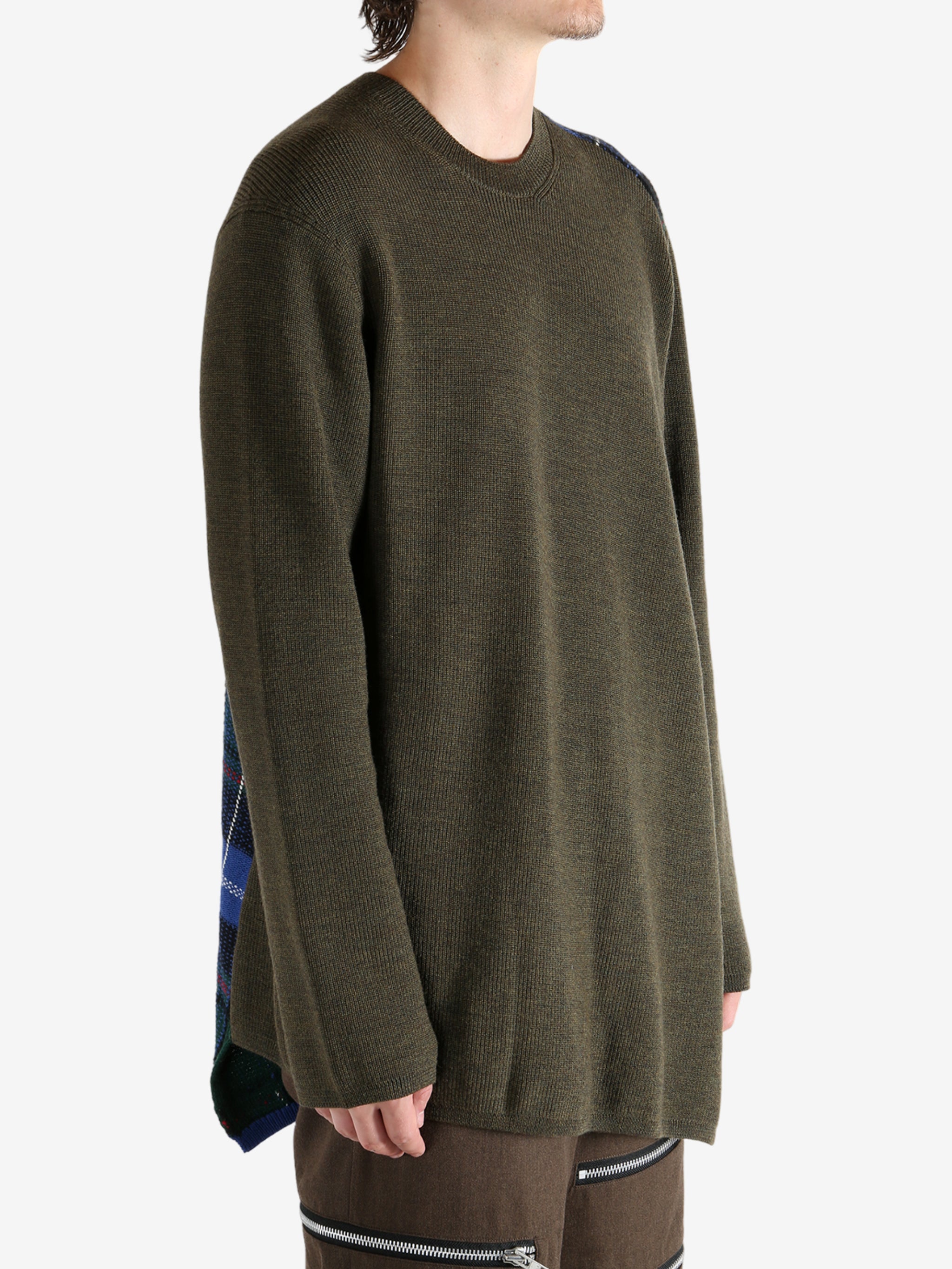 Green sweater worn by a person, showing the sweater's fit