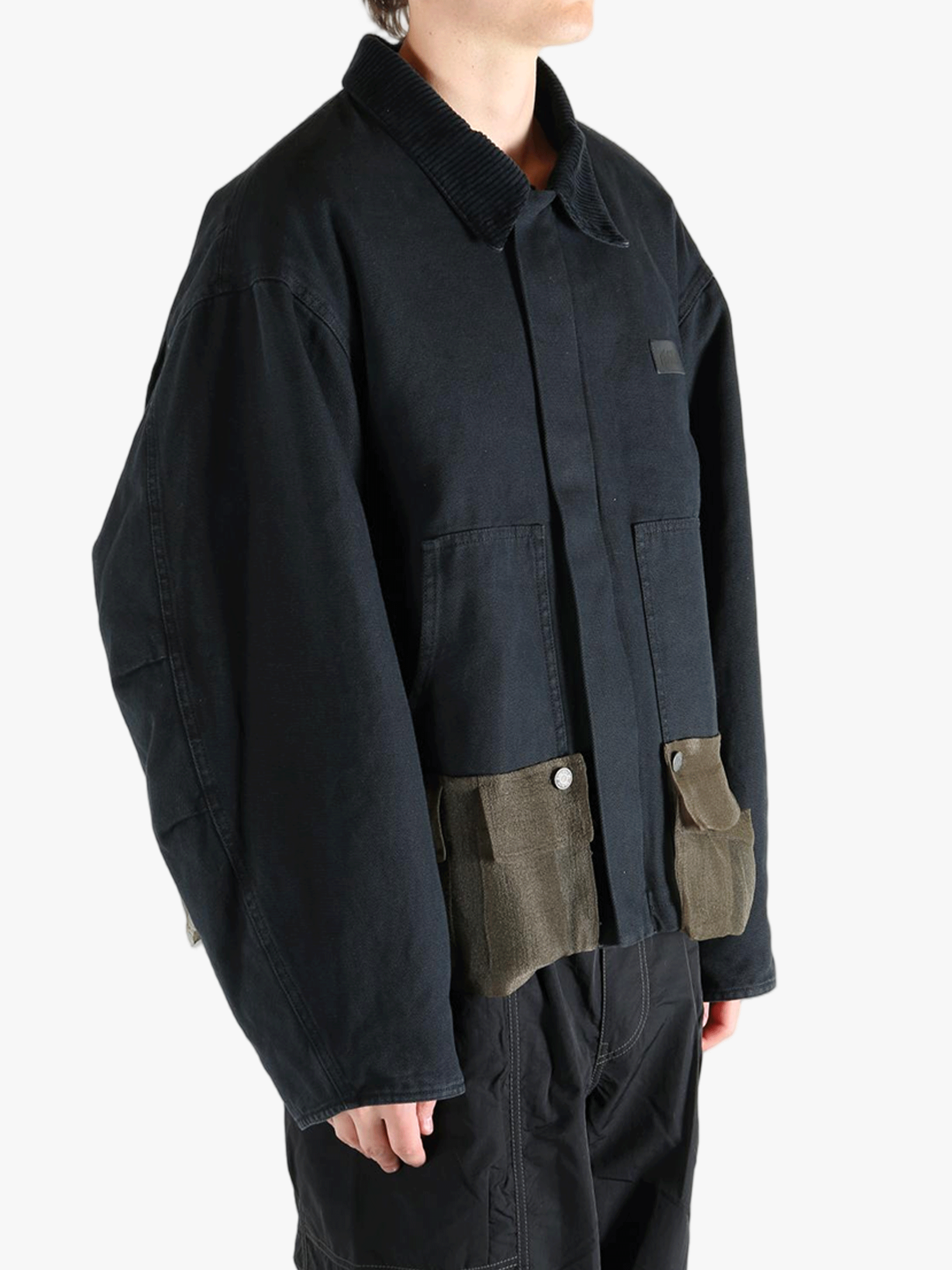 Black jacket worn by a person, showing the jacket's fit