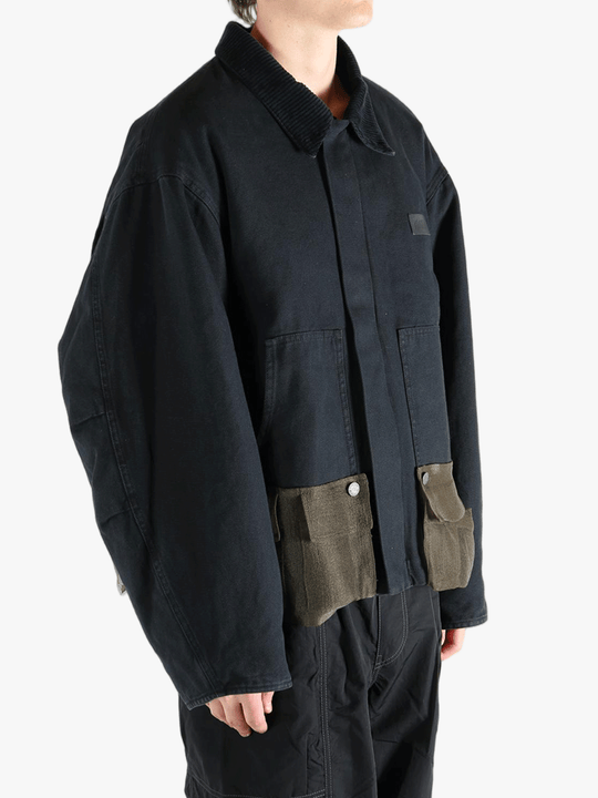 Black jacket worn by a person, showing the jacket's fit