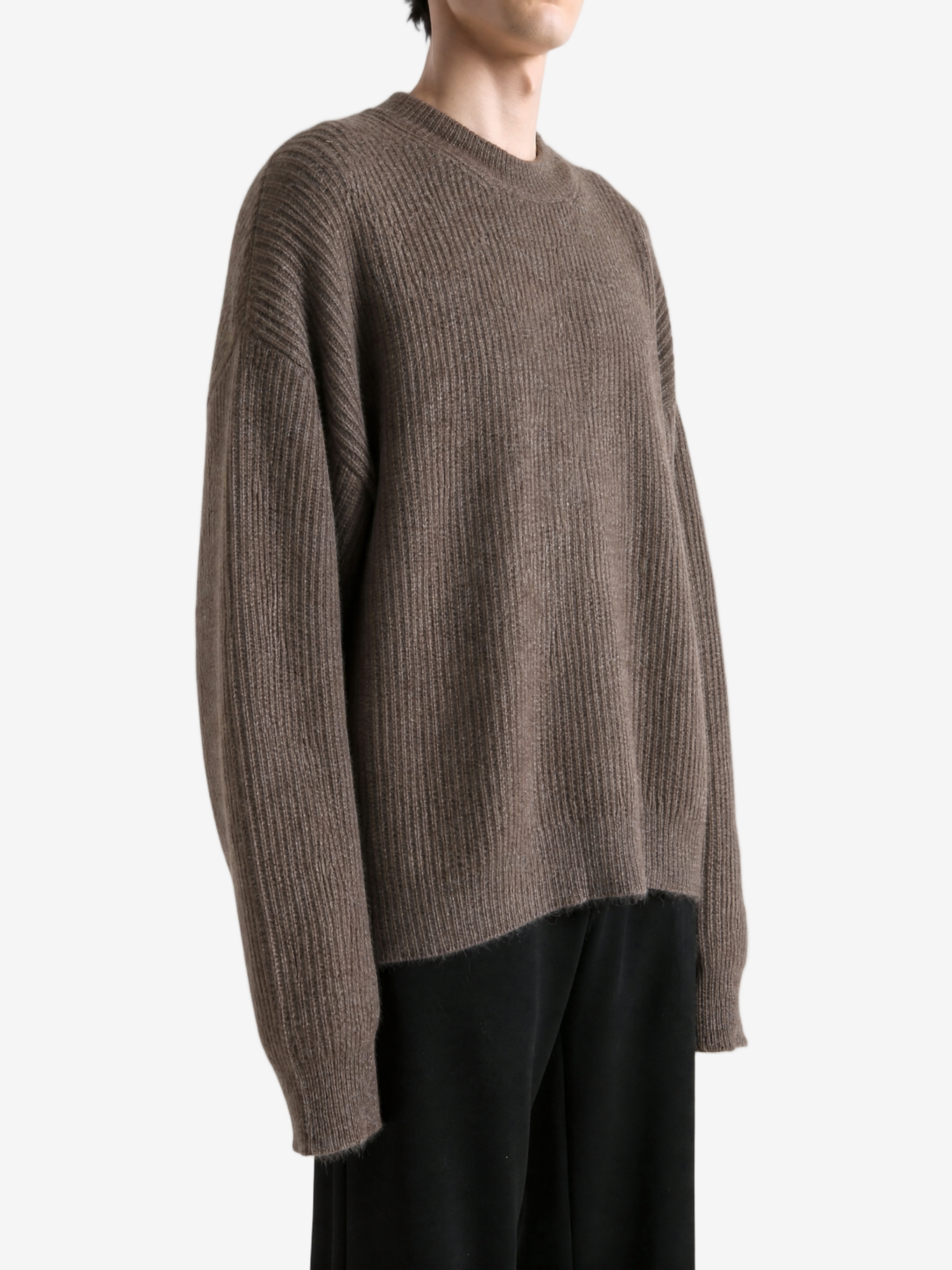 Brown knitwear worn by a person, showing the knitwear fit