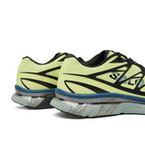 Close up of yellow sneakers, showing texture of the polyester fabric