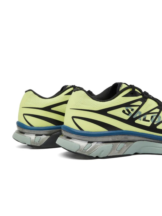 Close up of yellow sneakers, showing texture of the polyester fabric
