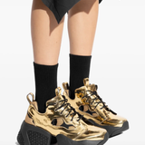 Black sneaker worn by a person, showing the sneakers fit