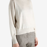 Grey knitwear worn by a person, showing the knitwear fit