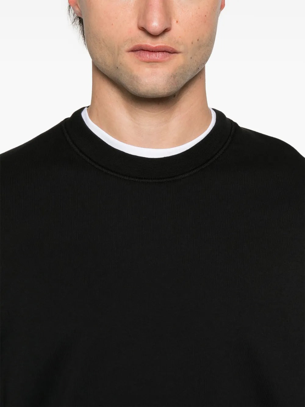 Close up of black sweatshirt, showing texture of the organic cotton fabric