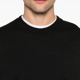 Close up of black sweatshirt, showing texture of the organic cotton fabric