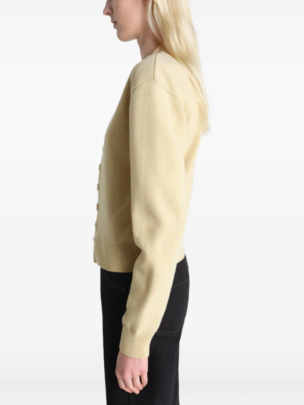 Tan knitwear worn by a person, showing the knitwear's fit