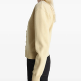 Tan knitwear worn by a person, showing the knitwear's fit
