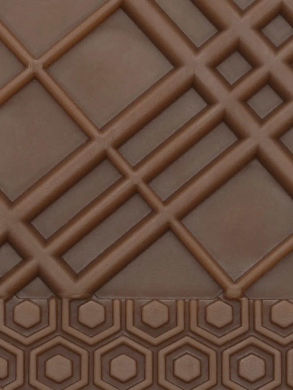 Close up of  tan sneakers, showing texture of the rubber fabric