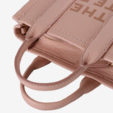 Close up of pink  bag, showing texture of the leather fabric