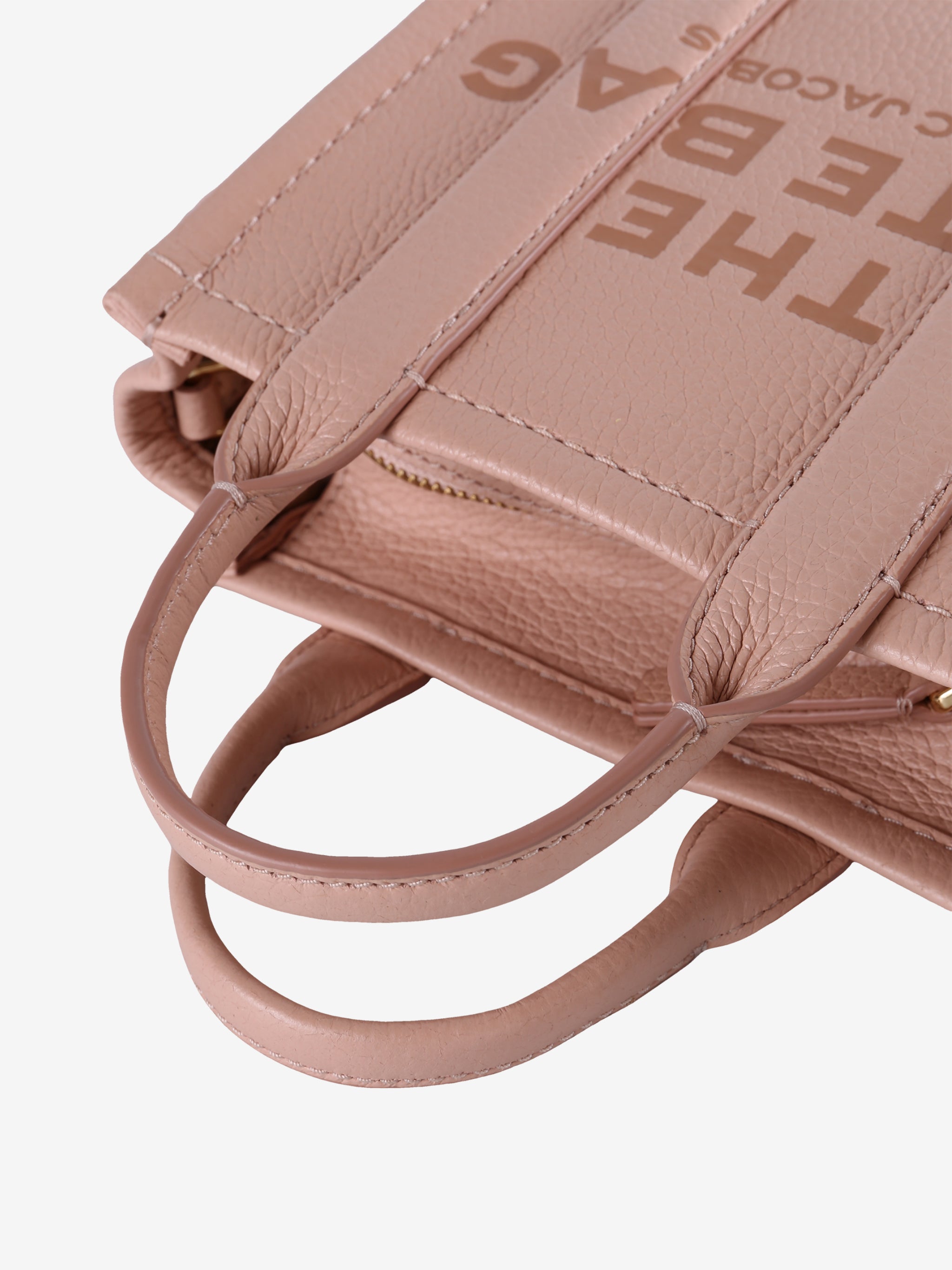 Close up of pink  bag, showing texture of the leather fabric