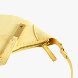Cloes-up of yellow bag, showing texture of the leather bag